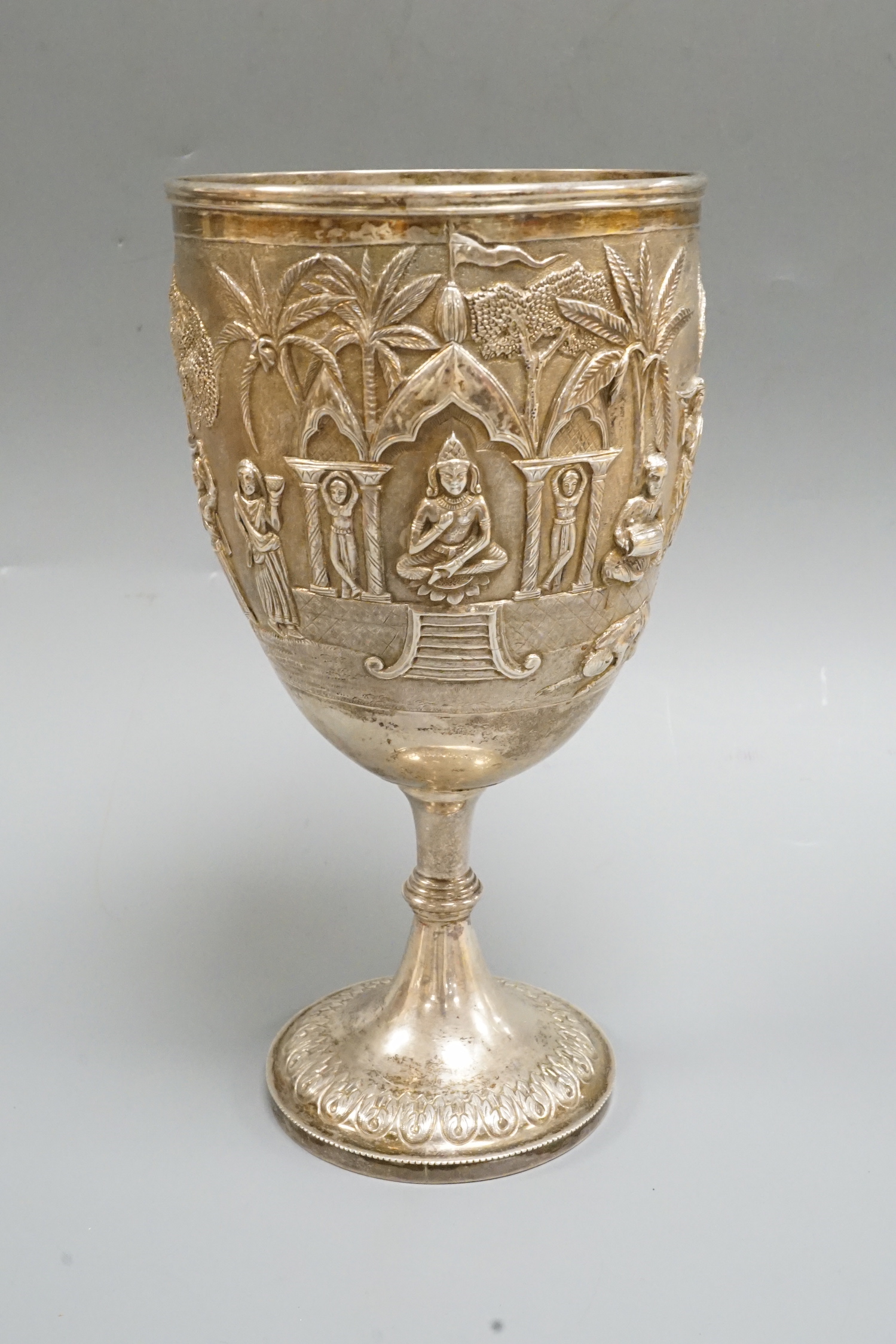 A 19th century Indian embossed white metal presentation goblet, with engraved inscription, 22.7cm, 14.7oz.